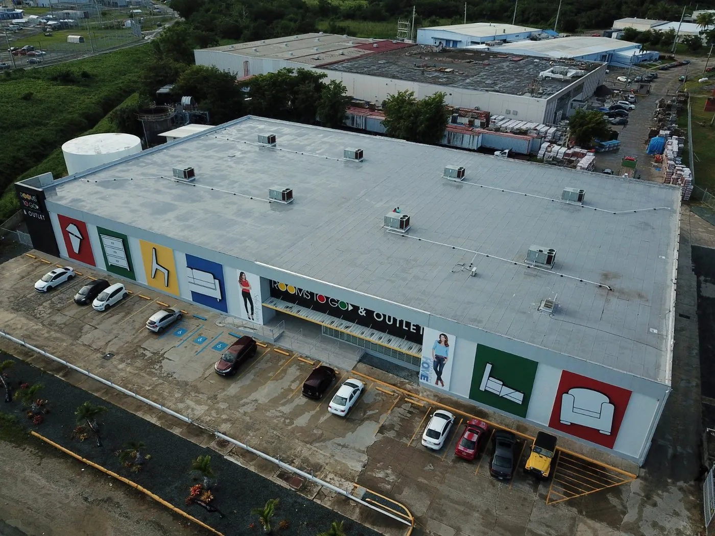 Aerial view of an industrial roof with solar panels in Humacao